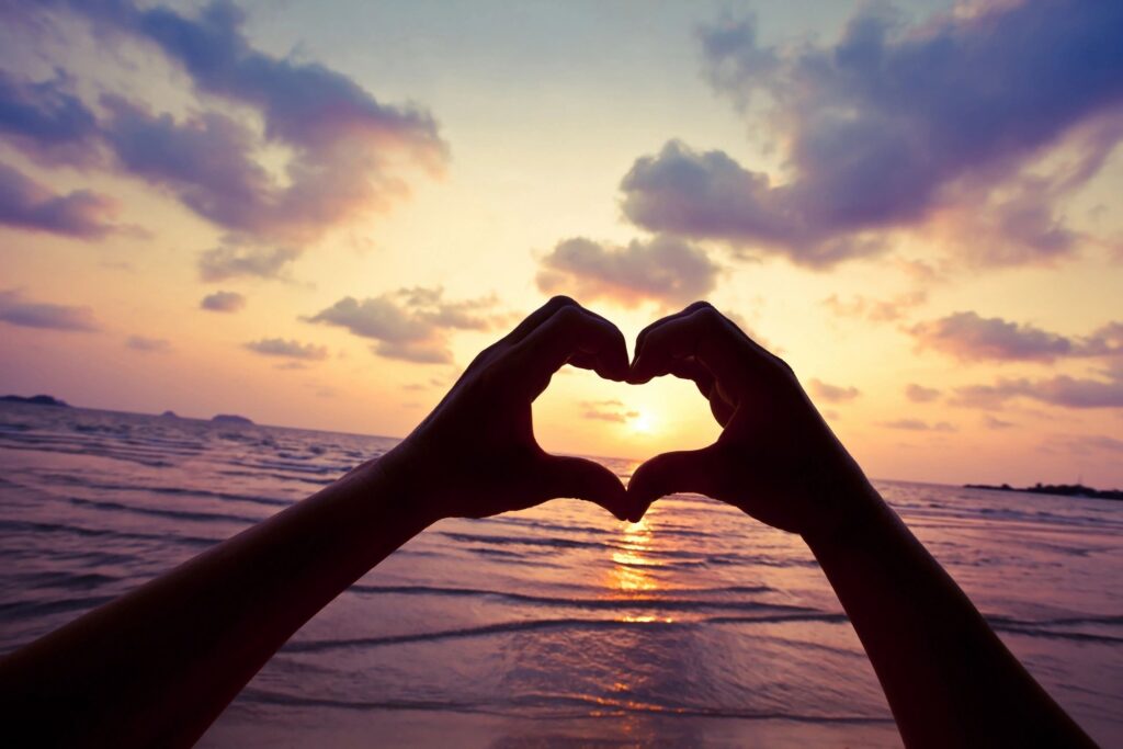 A couple walking hand in hand along a scenic beach at sunset, symbolizing traveling for a romantic Valentine's Day getaway